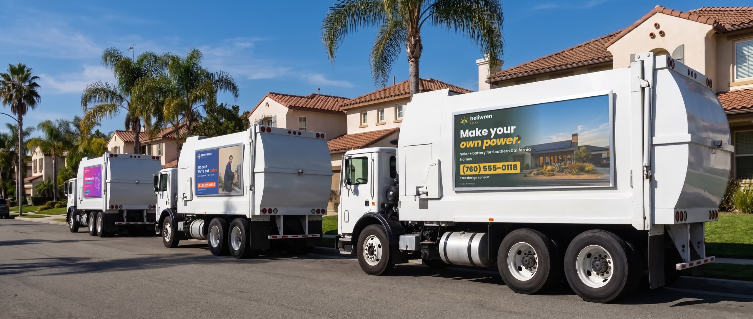Three white city garbage trucks parked along a residential street, each carrying a different local business ad