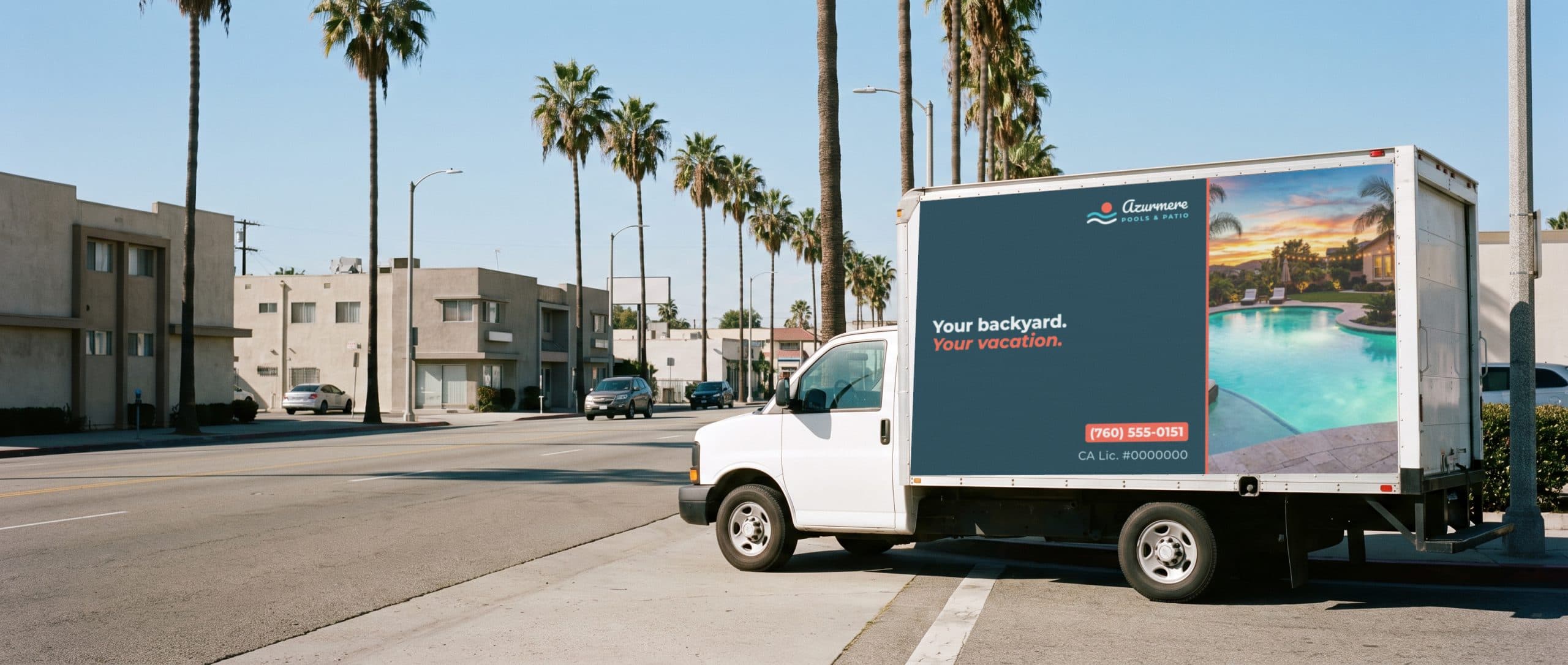 A mobile billboard truck on a sunny Southern California boulevard, carrying a pool builder ad.