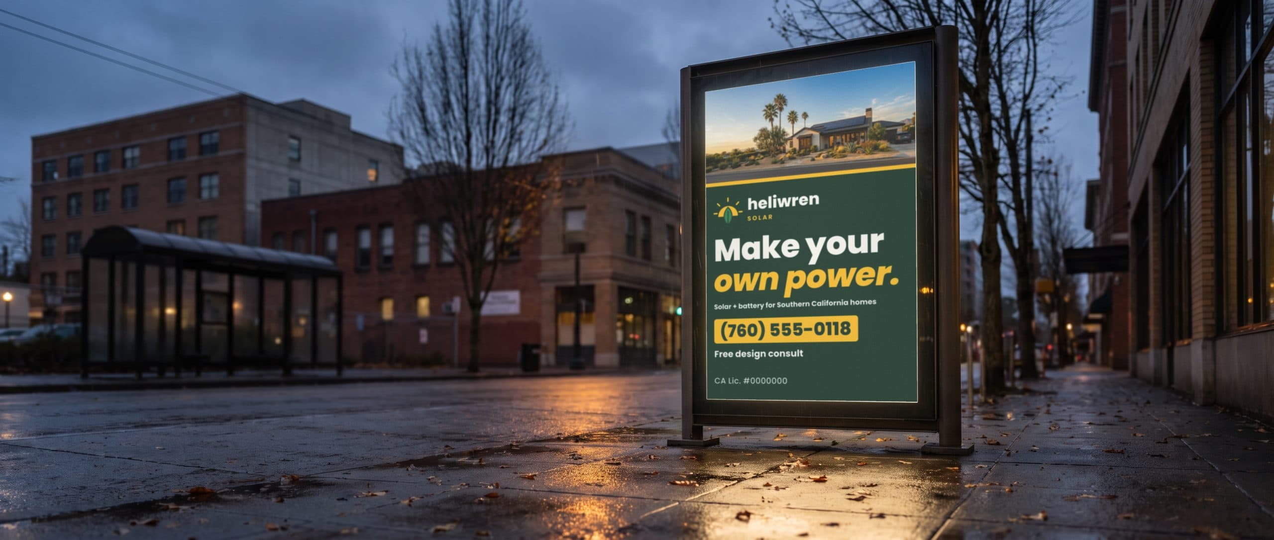 A lit sidewalk kiosk on a rainy Pacific Northwest evening, showing a solar company ad.